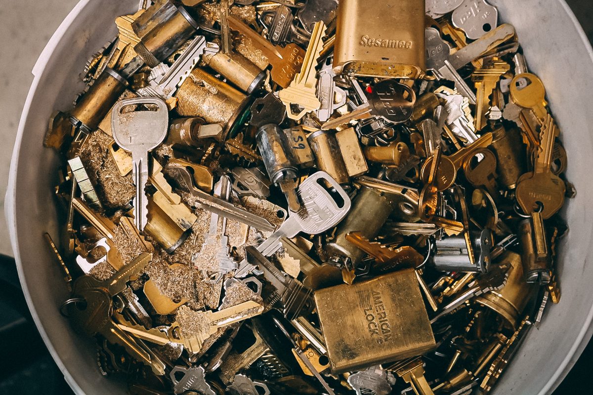 A bin full of brass keys and lock cylinders